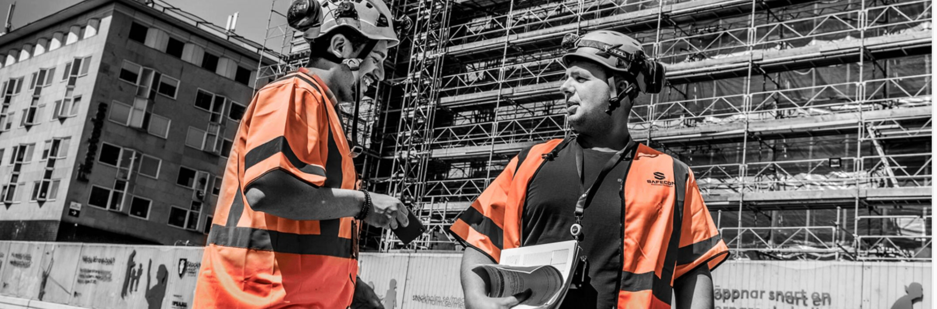 SafeCon ställningsbyggare i samtal framför byggarbetsplats